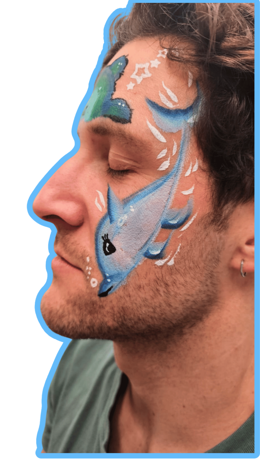 Man with blue fish design painted on his face against a green background